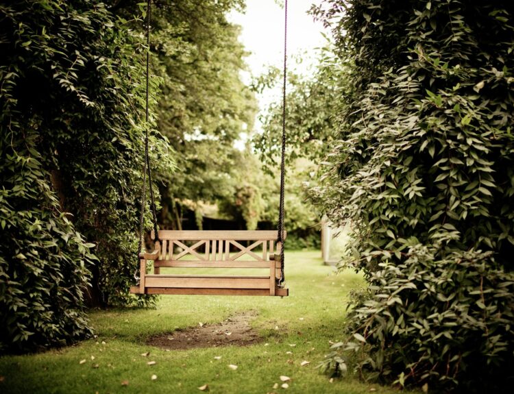 A swinging bench within a garden